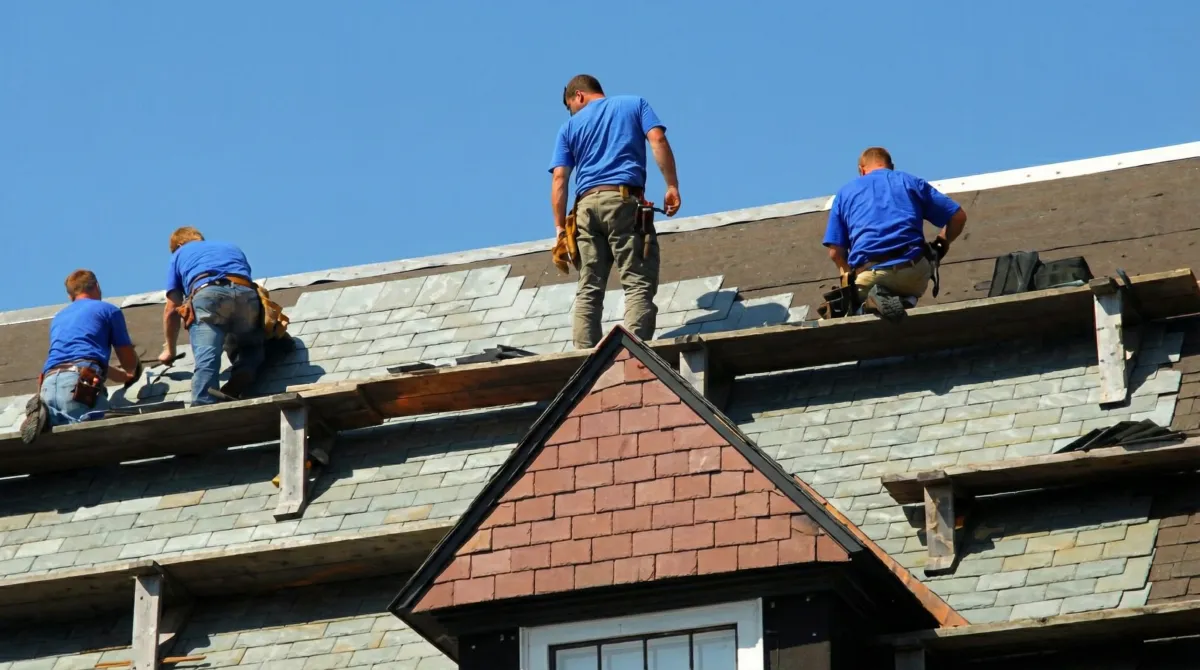 Roof replacement in progress with a team of professional contractors installing new shingles on a residential home in San Francisco, CA